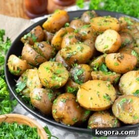 Hearty serving of Slow Cooker Garlic Herb Potatoes in a black bowl