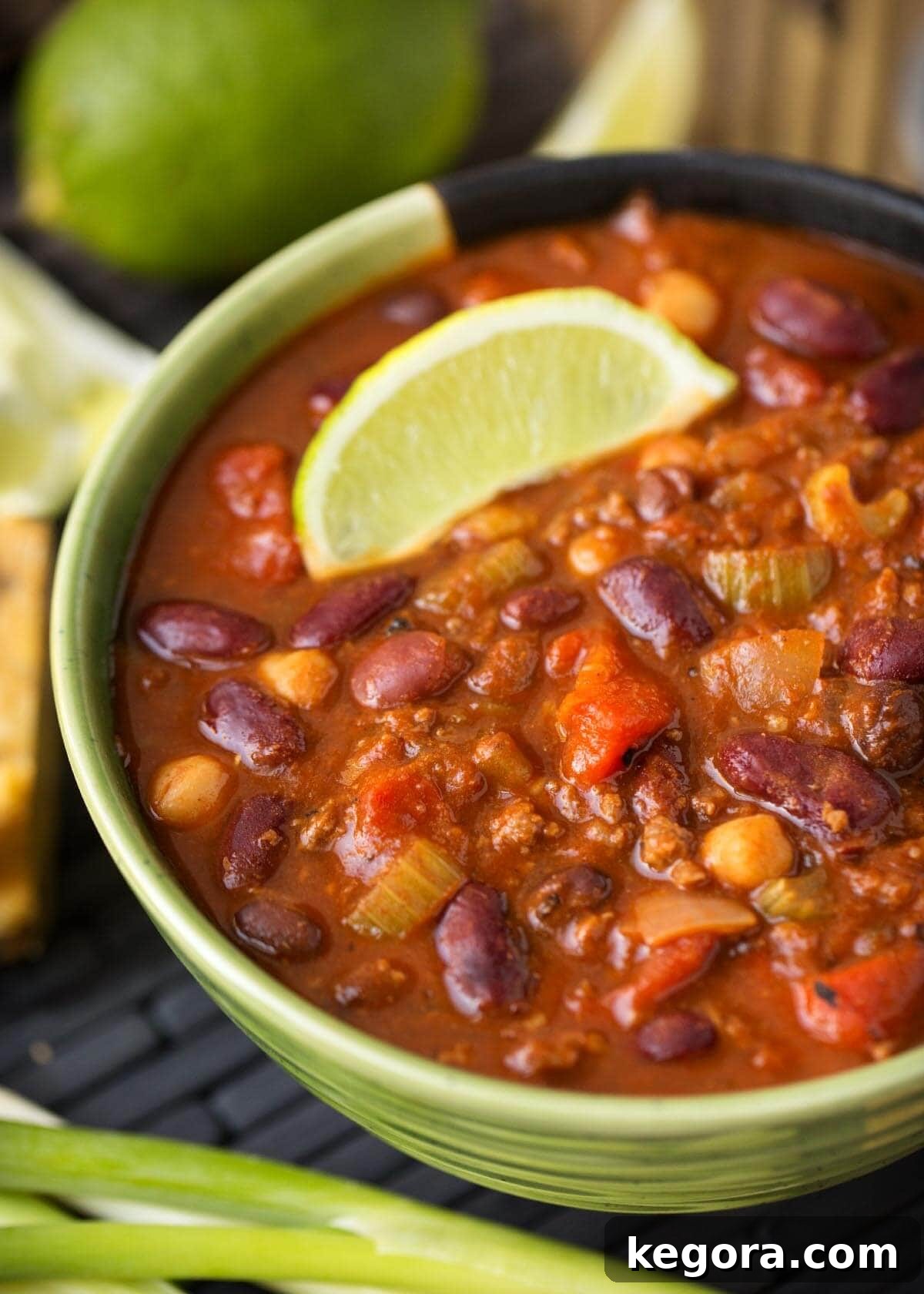 A steaming bowl of Instant Pot Chili, garnished with fresh cilantro and a lime wedge.
