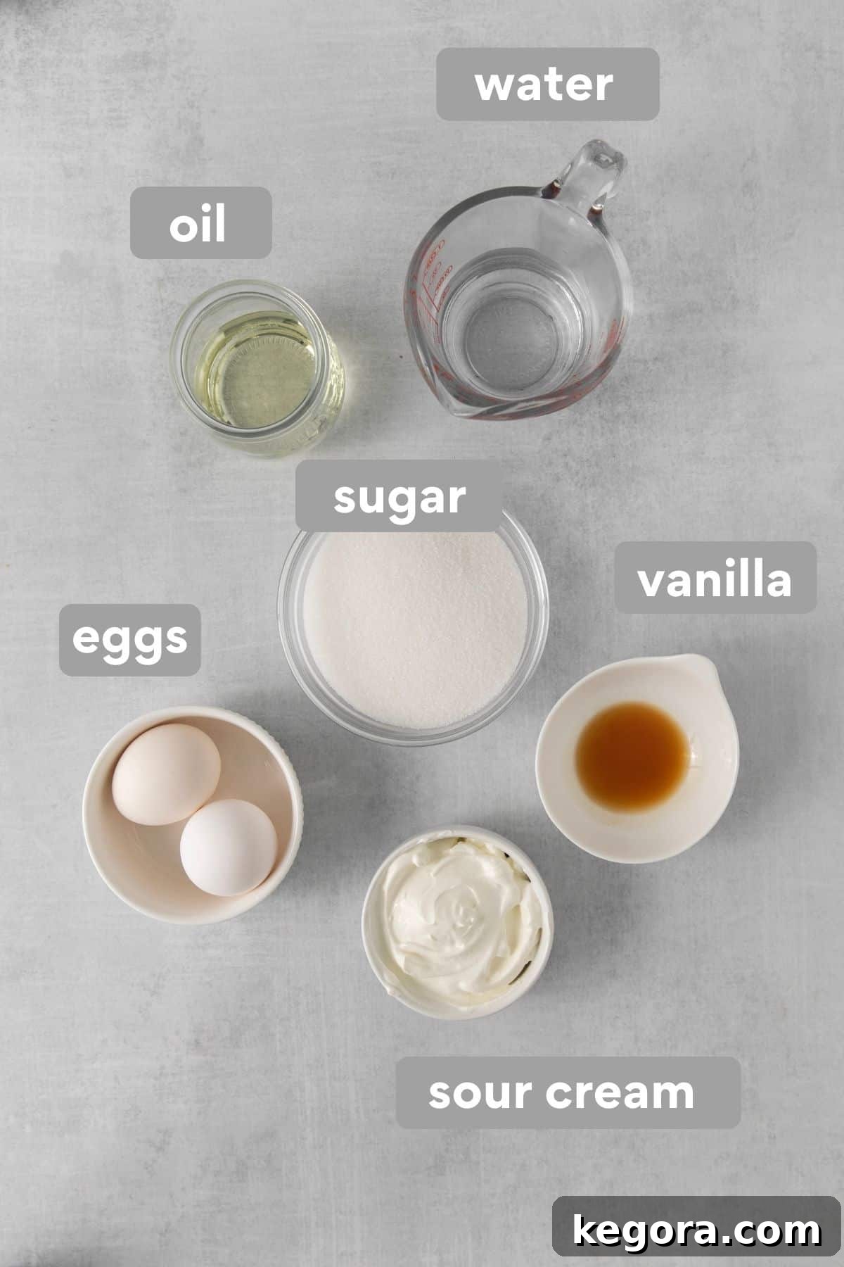 Decadent Gluten Free Chocolate Delights 3 Assortment of wet ingredients for gluten-free chocolate cupcakes, including oil, eggs, sour cream, and vanilla extract, arranged on a kitchen countertop.