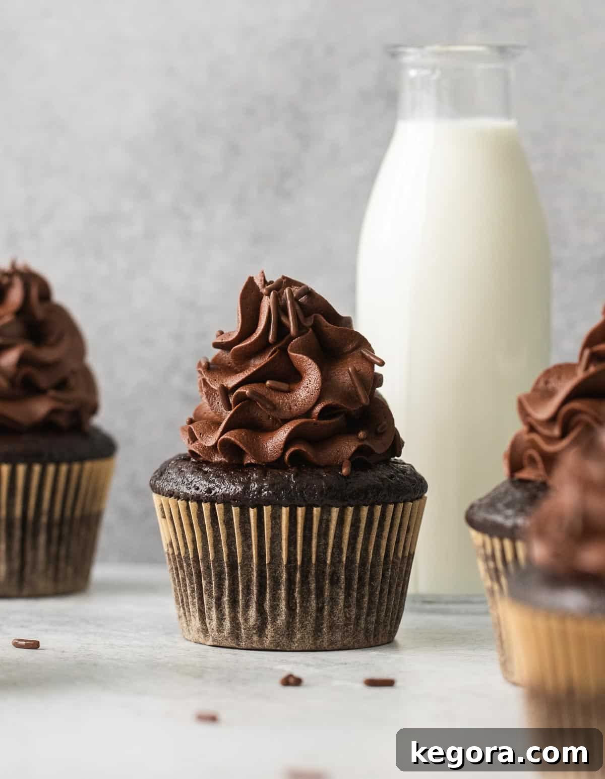 Decadent Gluten Free Chocolate Delights 10 A perfectly frosted gluten-free chocolate cupcake with a glass jar of milk in the soft-focus background, suggesting a delightful pairing.