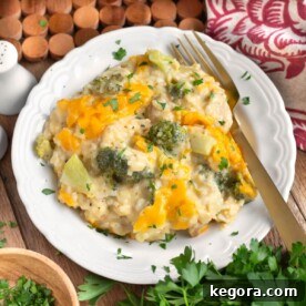 Cheesy Chicken Broccoli Rice Casserole on white plate with fork