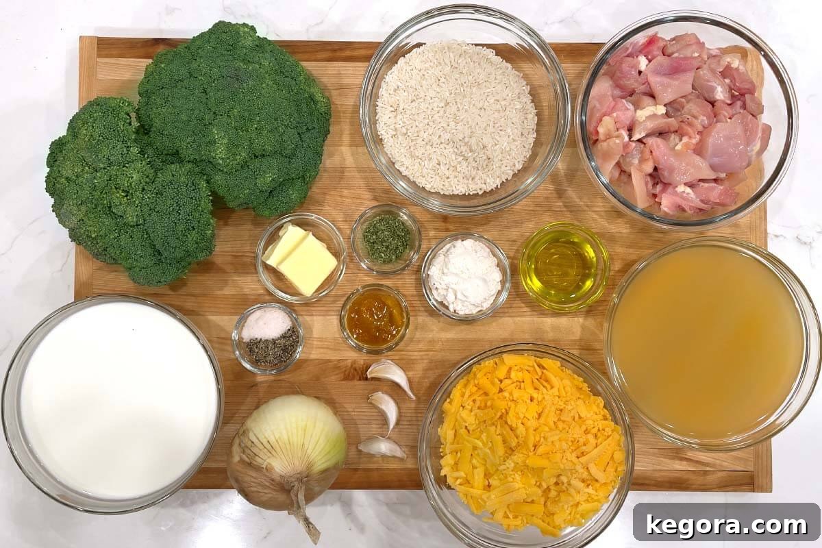 Creamy Cheddar Chicken Broccoli Rice Bake 4 A flat lay shot of all the ingredients for Cheesy Chicken Broccoli Rice Casserole laid out on a wooden board.
