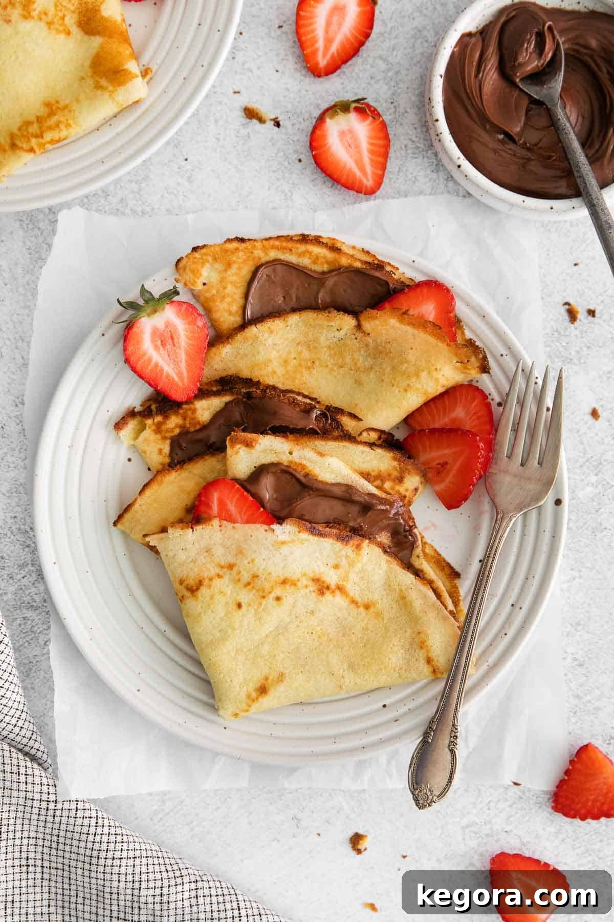 Crepes on a plate with a fork next to it
