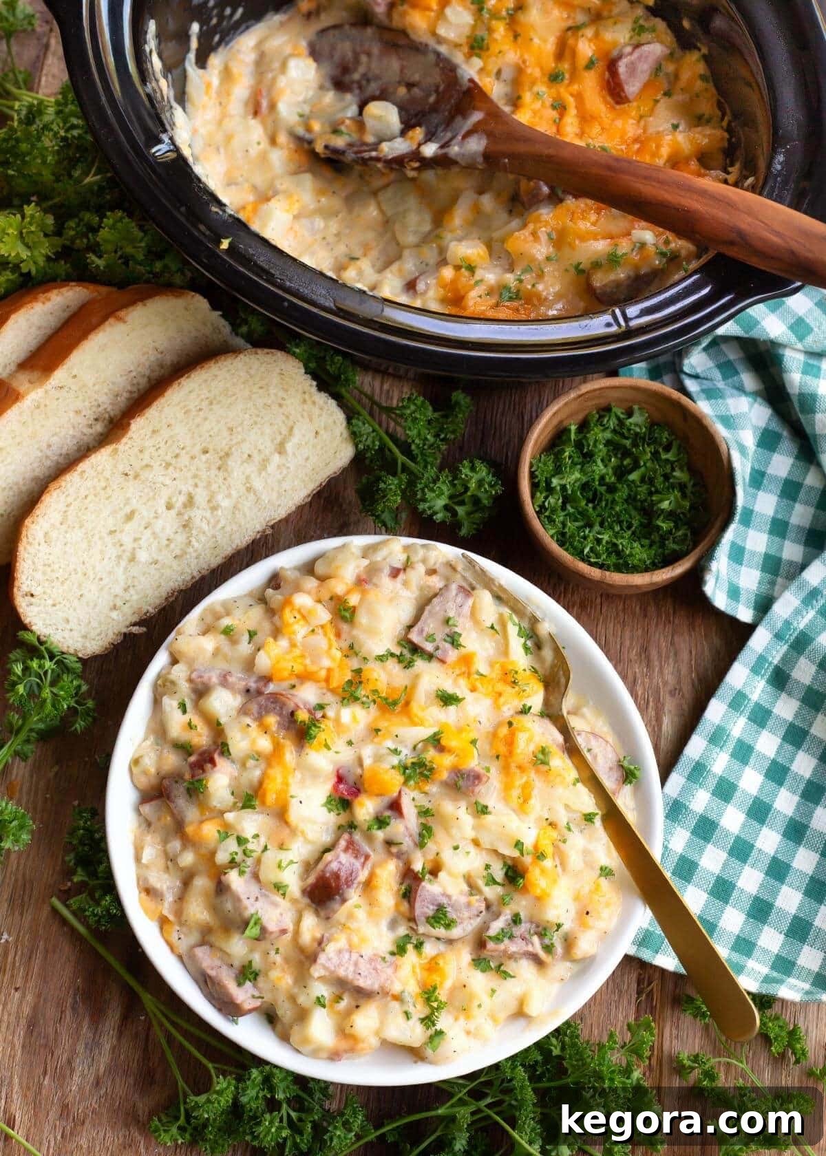 Crockpot Cheesy Potatoes with Kielbasa in a bowl and in a crockpot