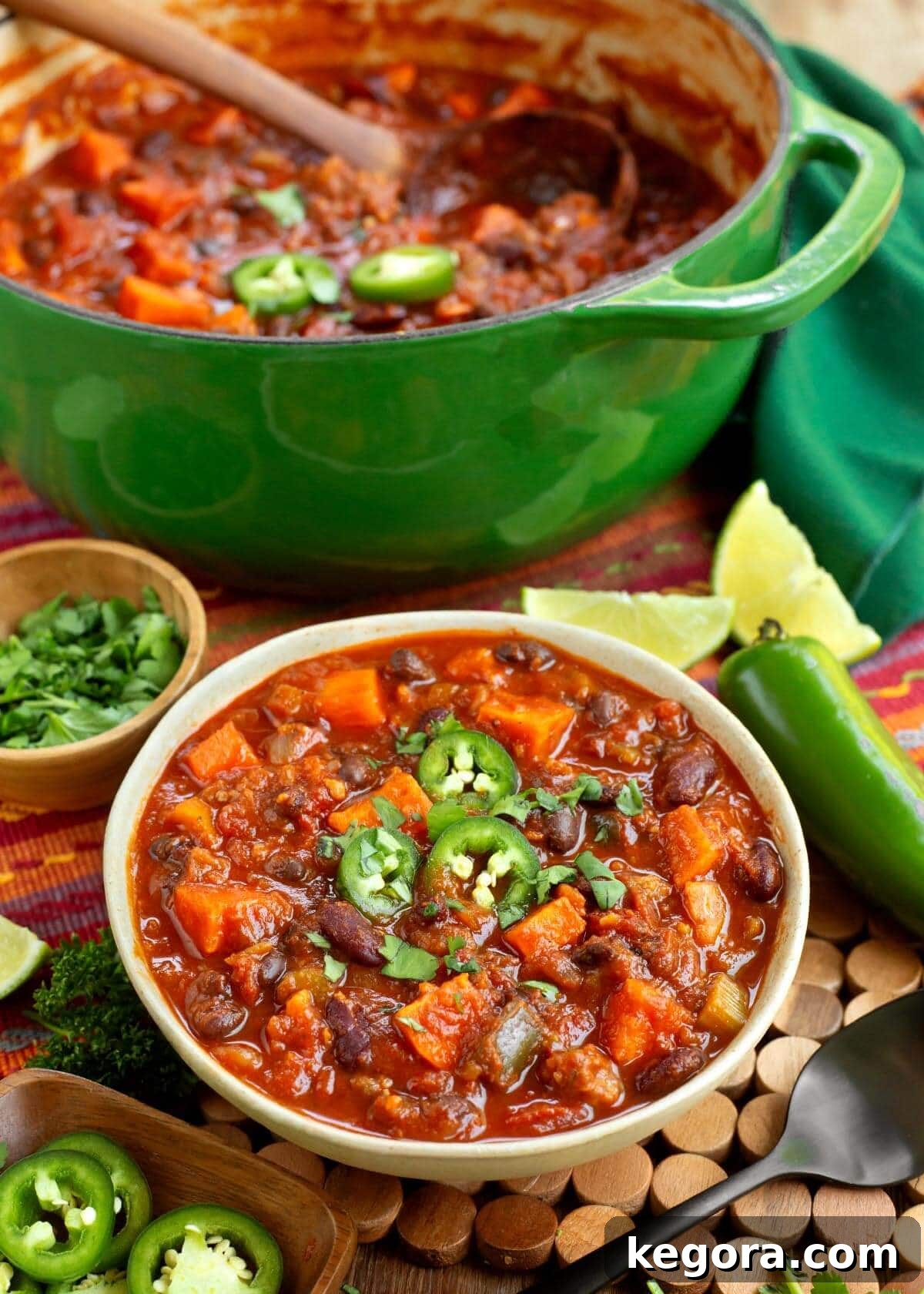 Sausage Sweet Potato Chili in a bowl with green pot behind