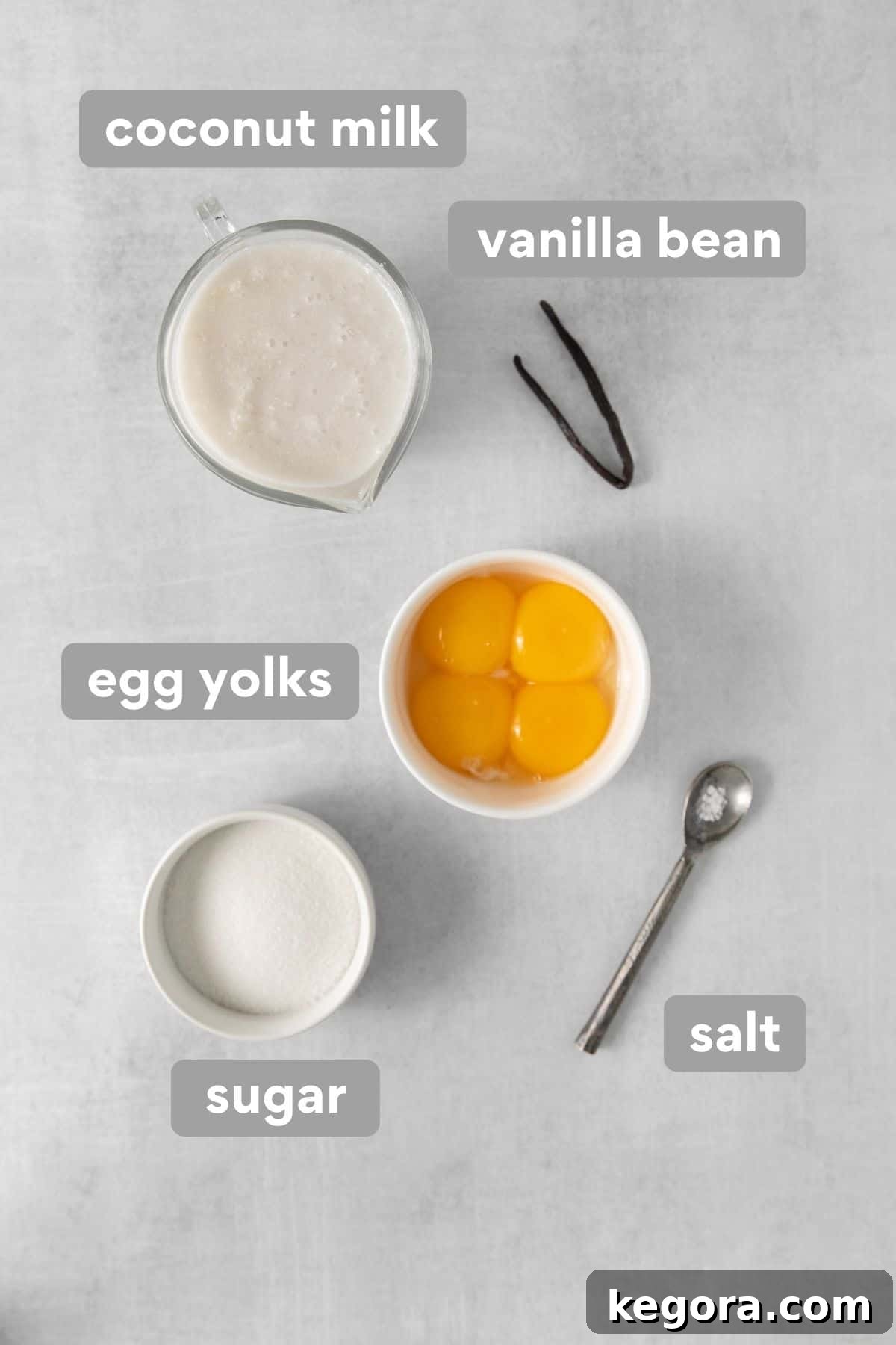 Dairy-Free Dream Brûlée 3 A beautifully arranged selection of dairy-free creme brulee ingredients on a clean countertop, showcasing fresh coconut milk, eggs, vanilla bean, and sugar.