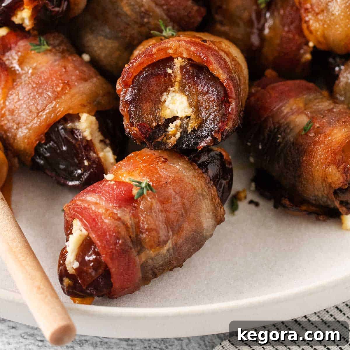 A beautifully presented plate of bacon-wrapped dates, ready to be enjoyed.