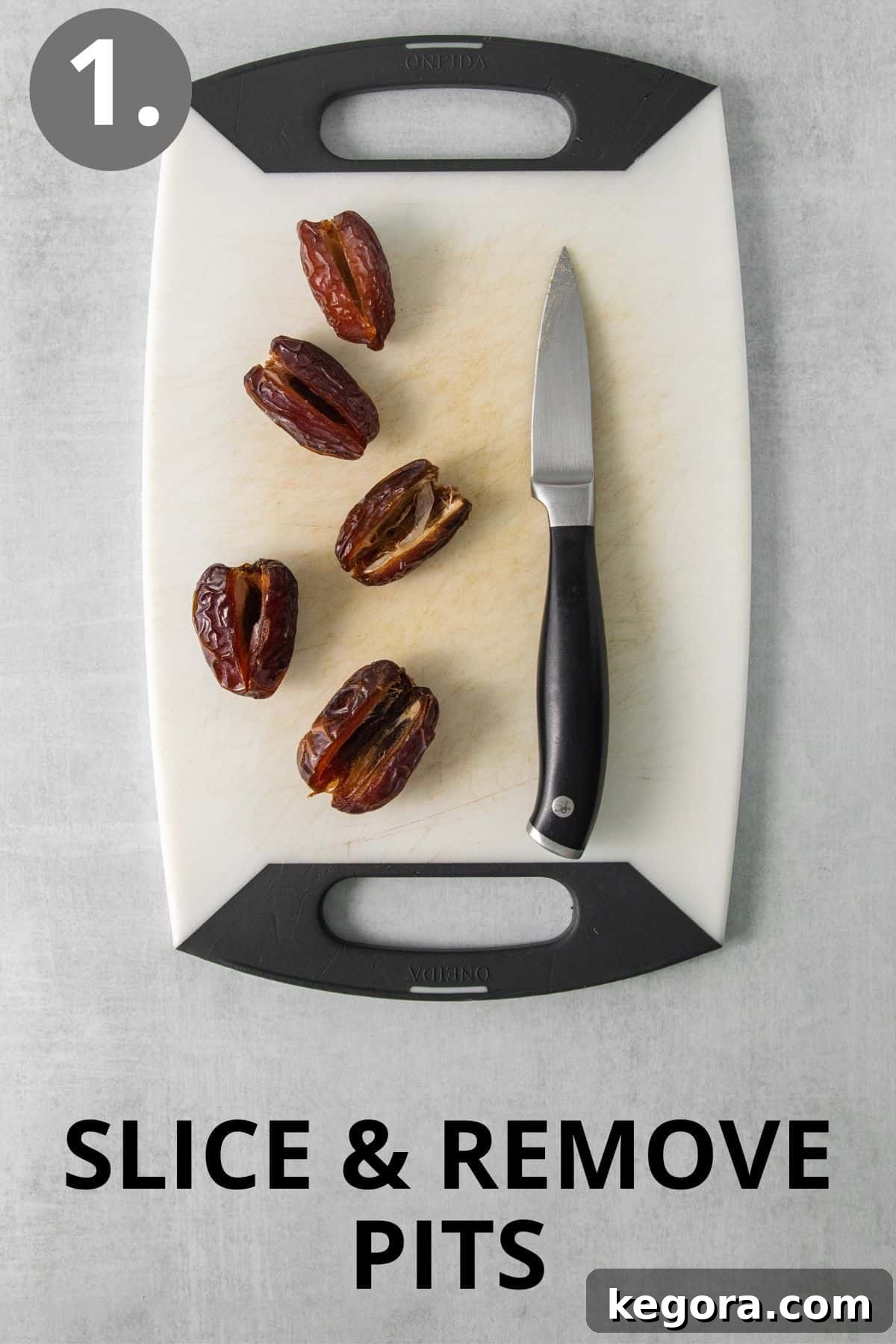 Dates and a knife on a cutting board, ready for preparation.