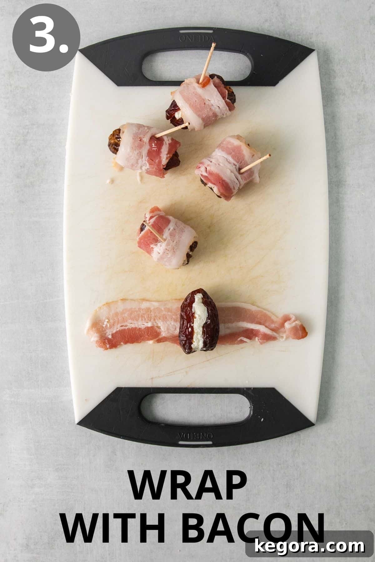 Cheese-filled dates being wrapped with raw bacon on a cutting board, ready for baking.