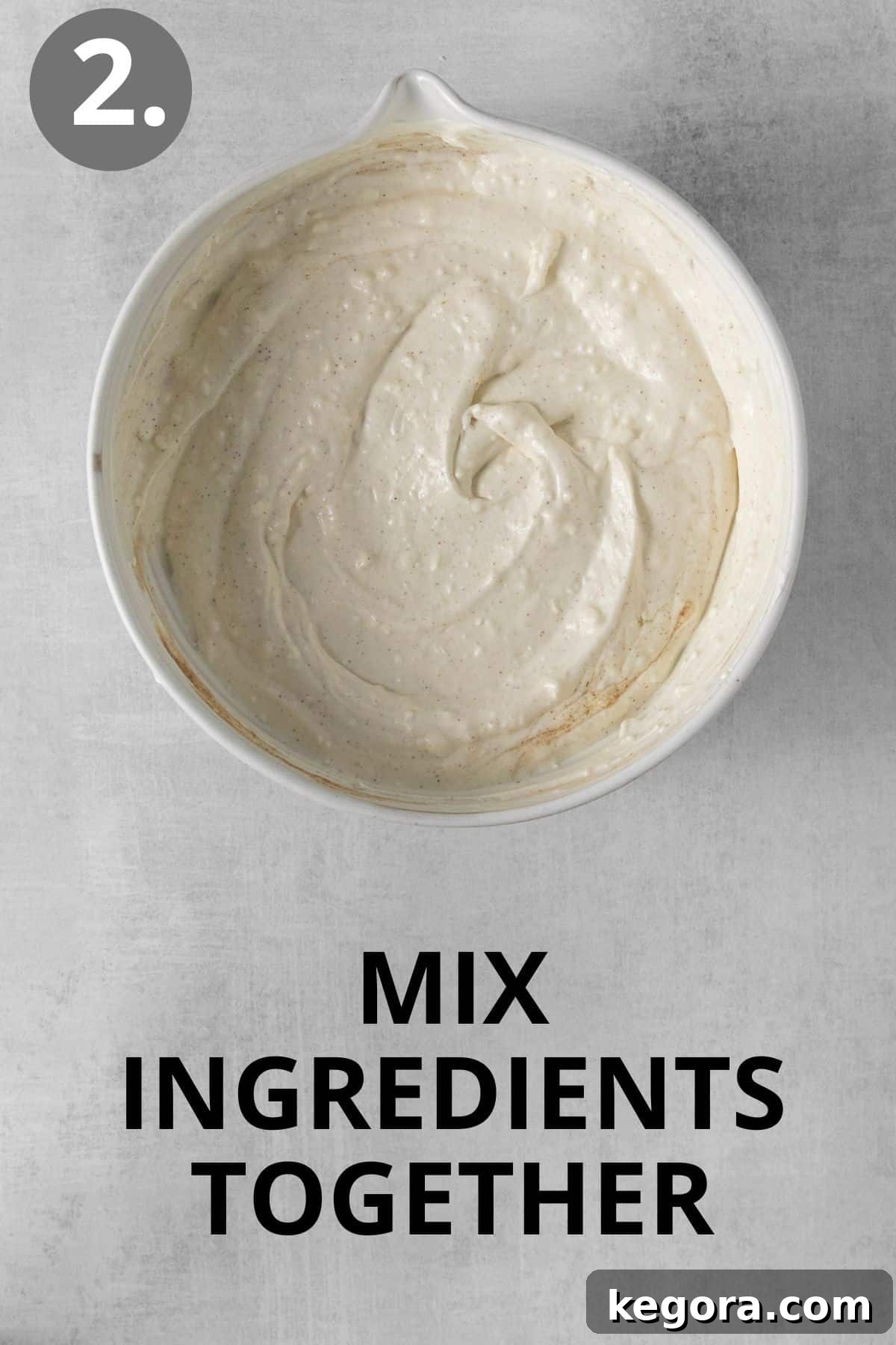 Ultimate Caramelized Onion Dip 6 Softened cream cheese, tangy sour cream, and rich mayonnaise being smoothly and thoroughly blended together in a pristine mixing bowl using an electric mixer, creating the impeccably creamy and uniform base of the onion dip.