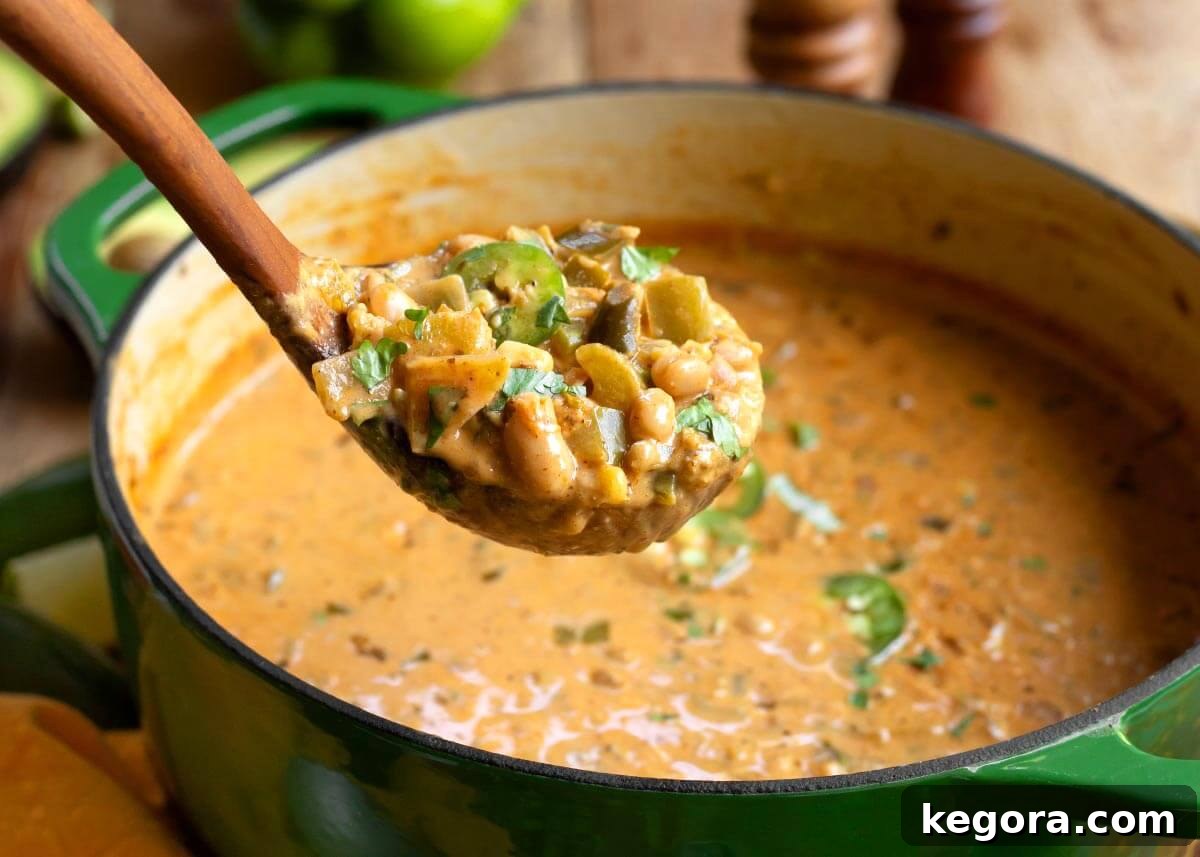 Plant-Powered White Bean Chili 3 Vegetarian White Bean Chili in a white bowl with a spoon