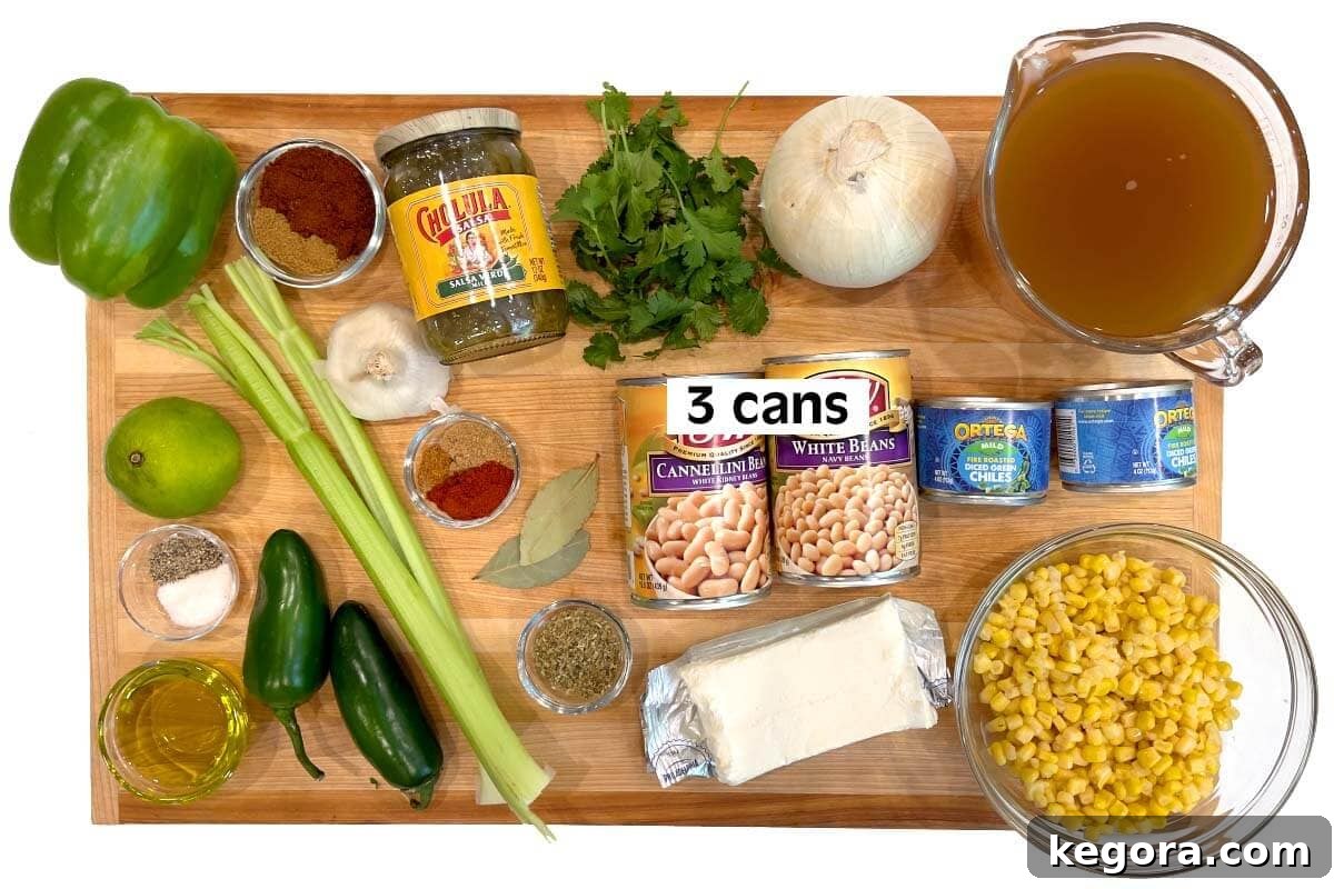 Plant-Powered White Bean Chili 4 Vegetarian White Bean Chili ingredients laid out on a wooden board