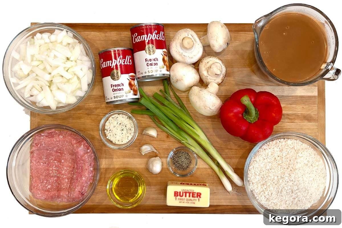 A flat lay shot of all the fresh ingredients for Hamburger Rice Casserole artfully arranged on a wooden board.