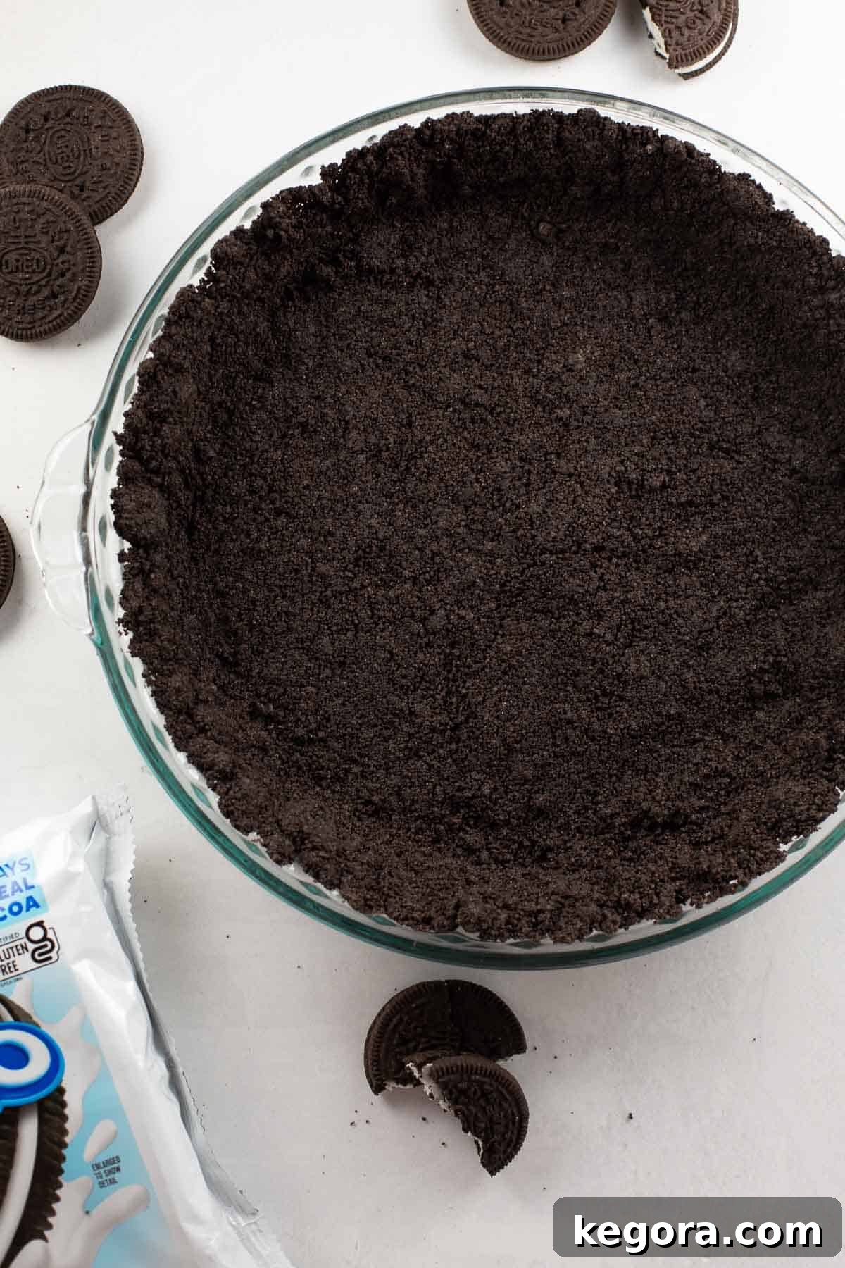 The Truth About Oreos and Gluten 5 An overhead shot of a perfectly set gluten-free Oreo pie crust in a clear glass pie plate, ready for filling.