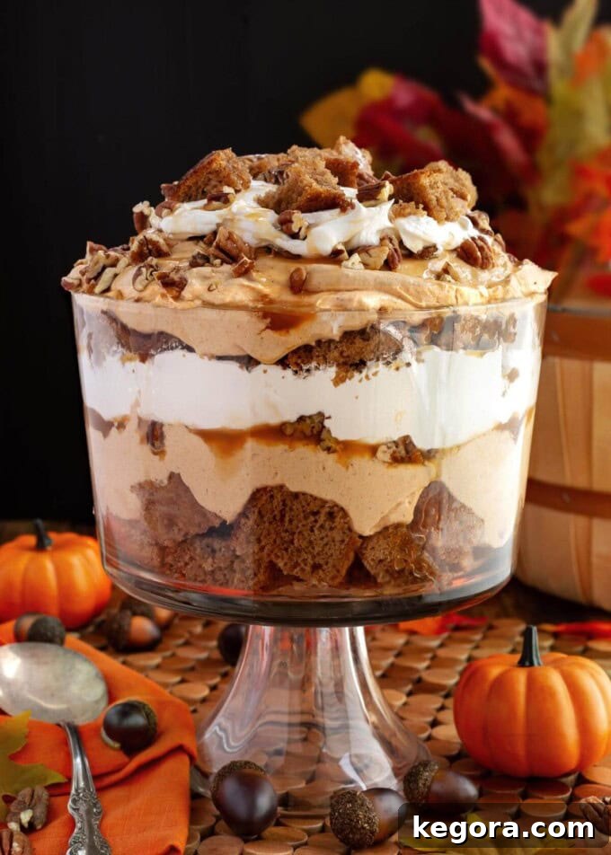 Stunning Make Ahead Pumpkin Trifle Fall Favorite 2 Layered Pumpkin Trifle dessert in a fall themed setting, showcasing its beautiful layers.