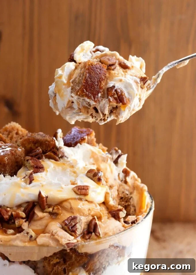 Stunning Make Ahead Pumpkin Trifle Fall Favorite 14 A spoonful of Pumpkin Trifle, showing all the layers, ready to be eaten.