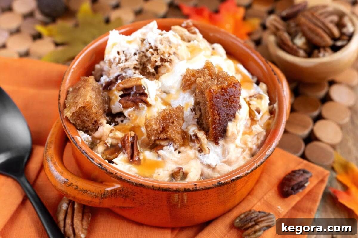Stunning Make Ahead Pumpkin Trifle Fall Favorite 3 A single serving of Pumpkin Trifle in an orange bowl, showing the rich texture.