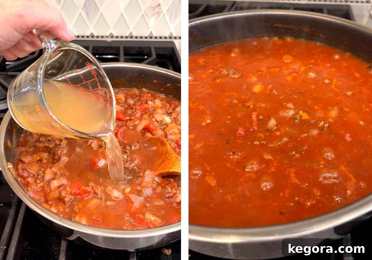 Savory One-Pan Beef and Cabbage Dinner 6 Simmering the ground beef and tomato sauce mixture with beef broth in a skillet to reduce slightly.