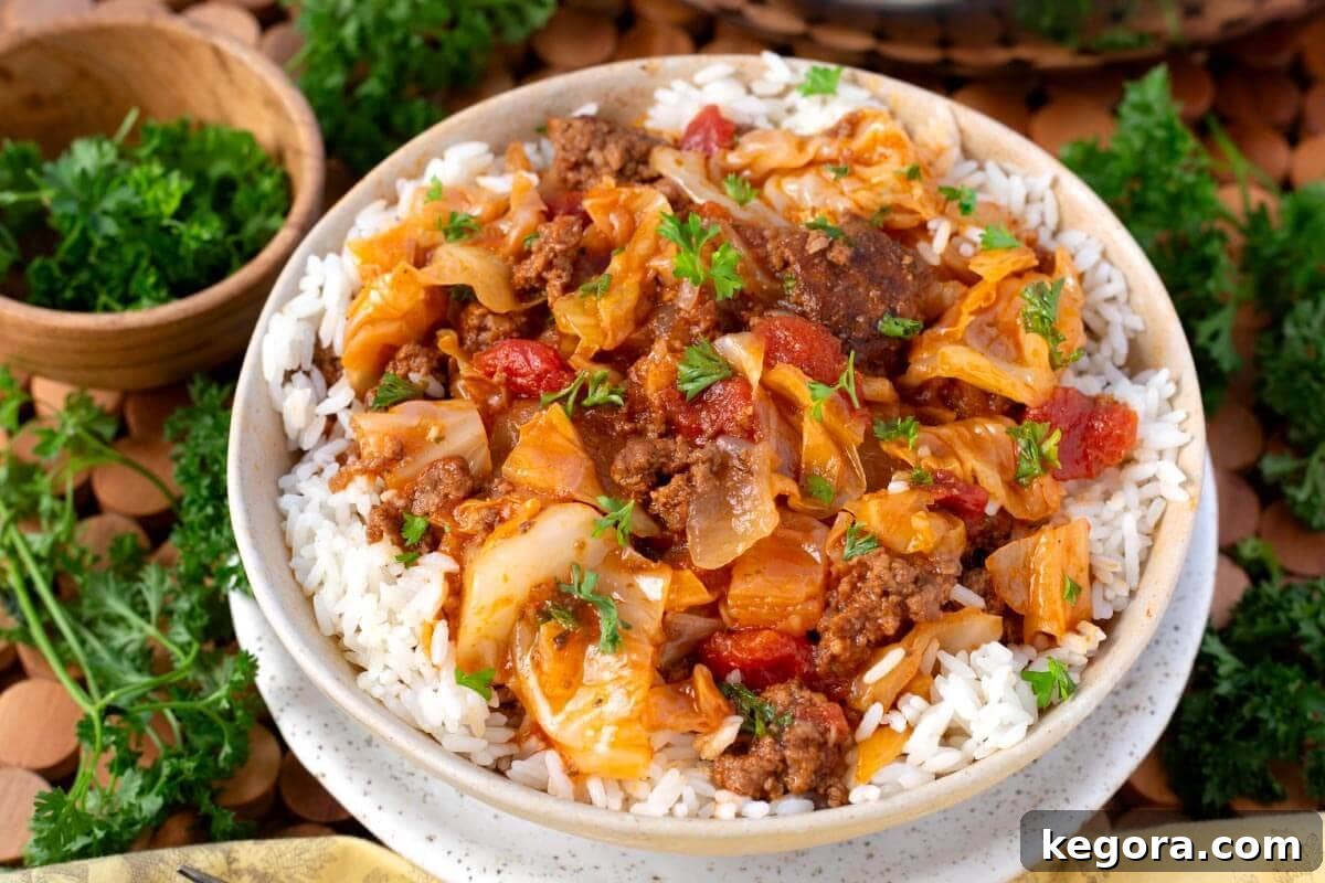 Savory One-Pan Beef and Cabbage Dinner 9 A generous serving of hearty Ground Beef Cabbage Skillet on a wooden spoon, ready to be enjoyed.