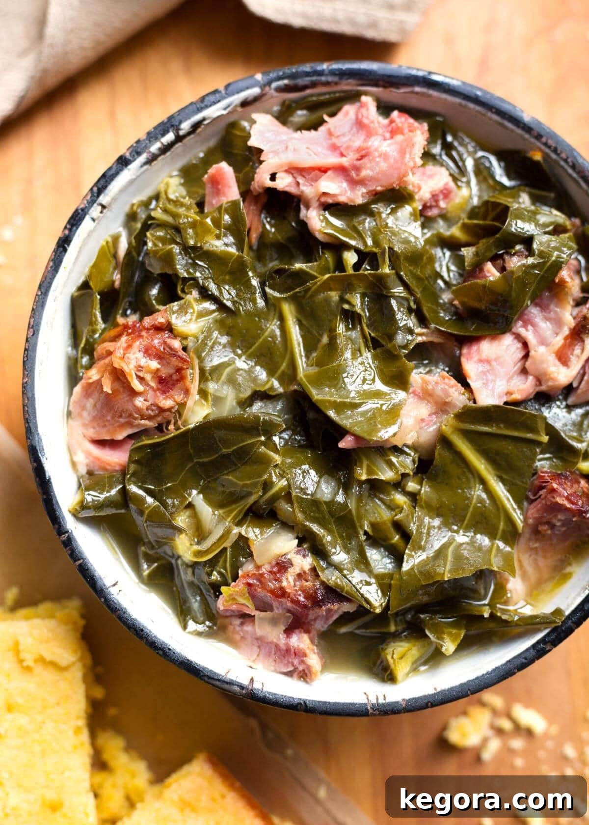Southern Instant Pot Collards 2 Rich and tender Instant Pot Collard Greens served in a rustic bowl, garnished with a sprig of fresh herbs.