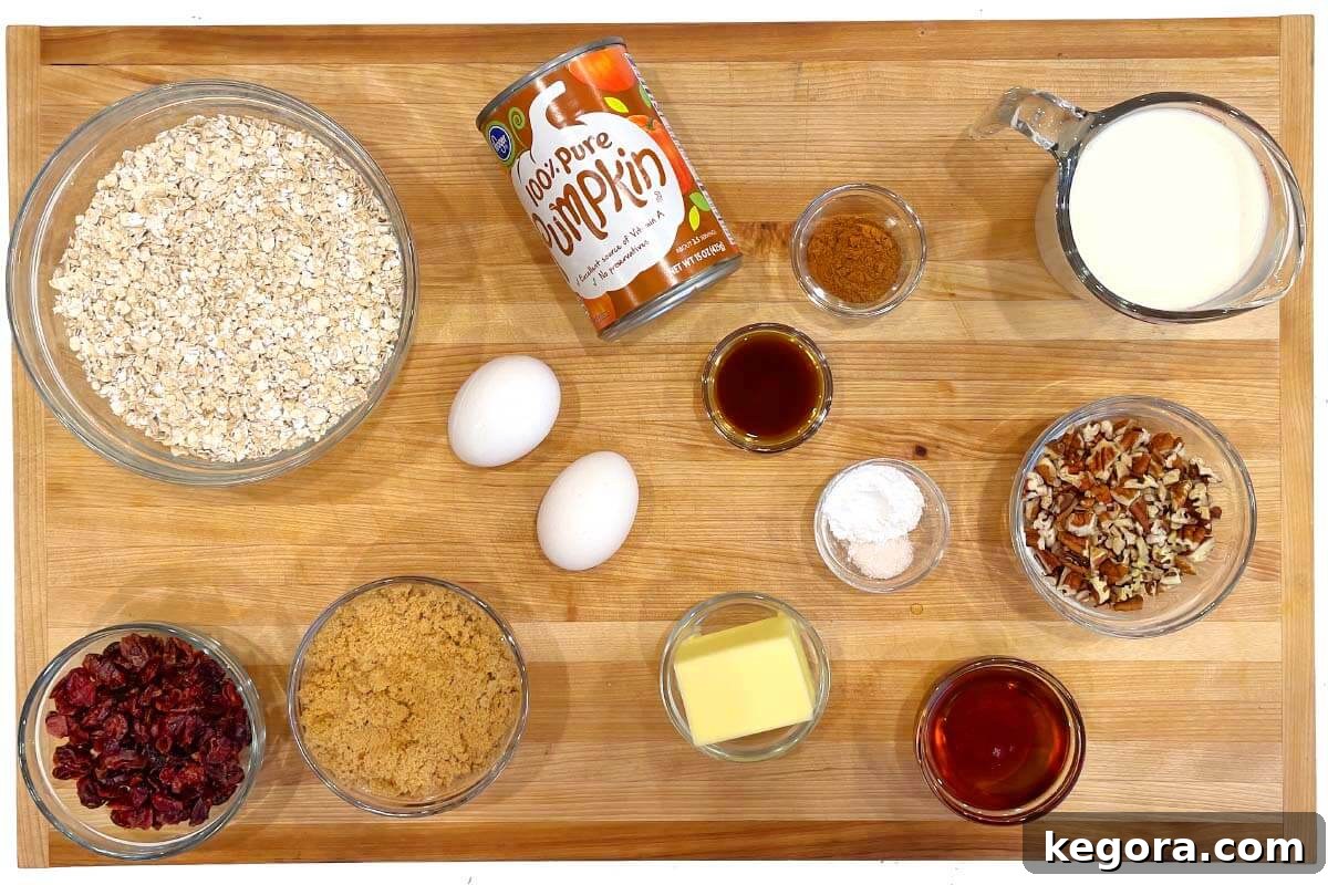 Cozy Morning Pumpkin Oatmeal Bake 4 Assortment of ingredients for Make-Ahead Pumpkin Baked Oatmeal laid out on a wooden board