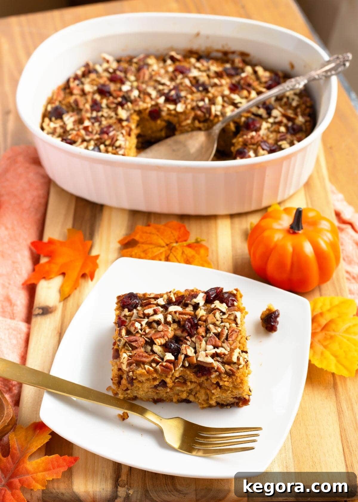 Cozy Morning Pumpkin Oatmeal Bake 10 Close-up of a slice of Make-Ahead Pumpkin Baked Oatmeal, showing its custardy texture, cranberries, and pecans