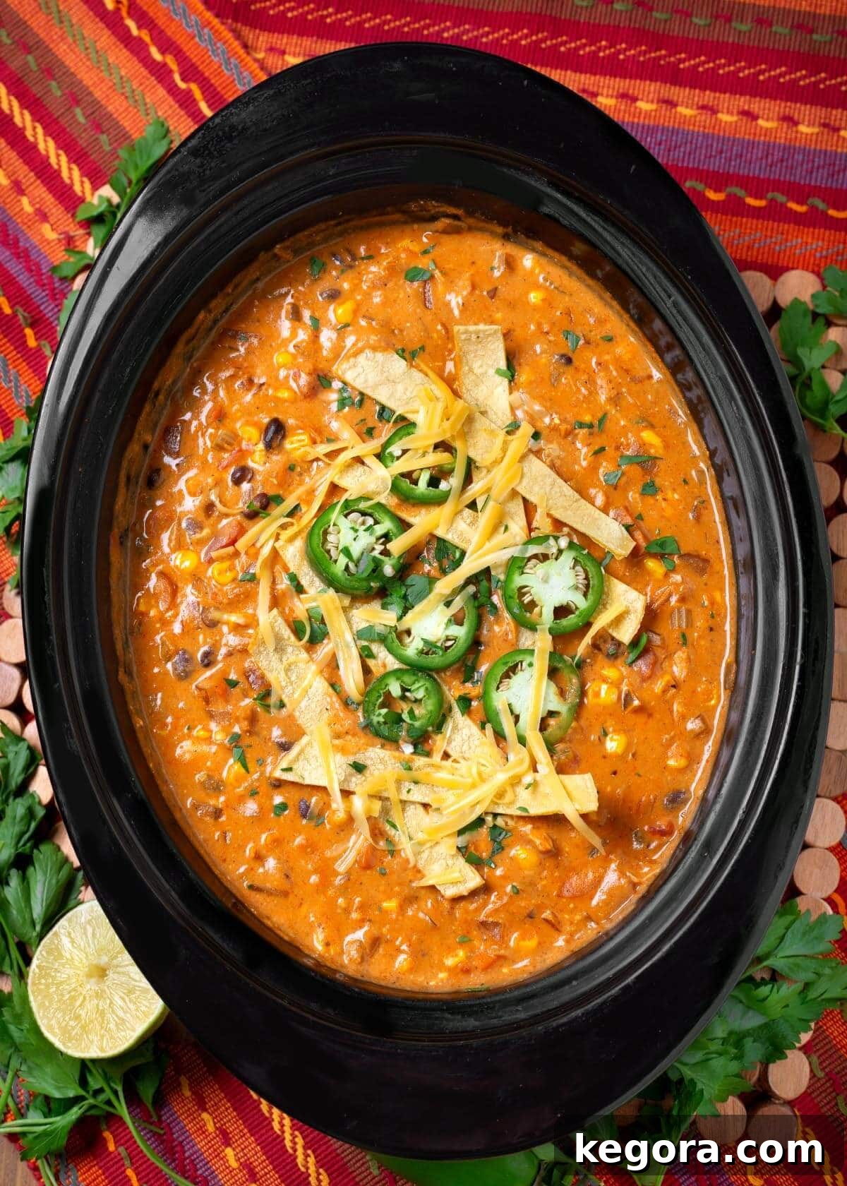 Slow Cooker Southwest Chicken Tortilla Soup 11 A beautifully presented bowl of Crockpot Chicken Tortilla Soup, garnished with fresh avocado, cilantro, and crispy tortilla strips, ready to be enjoyed.