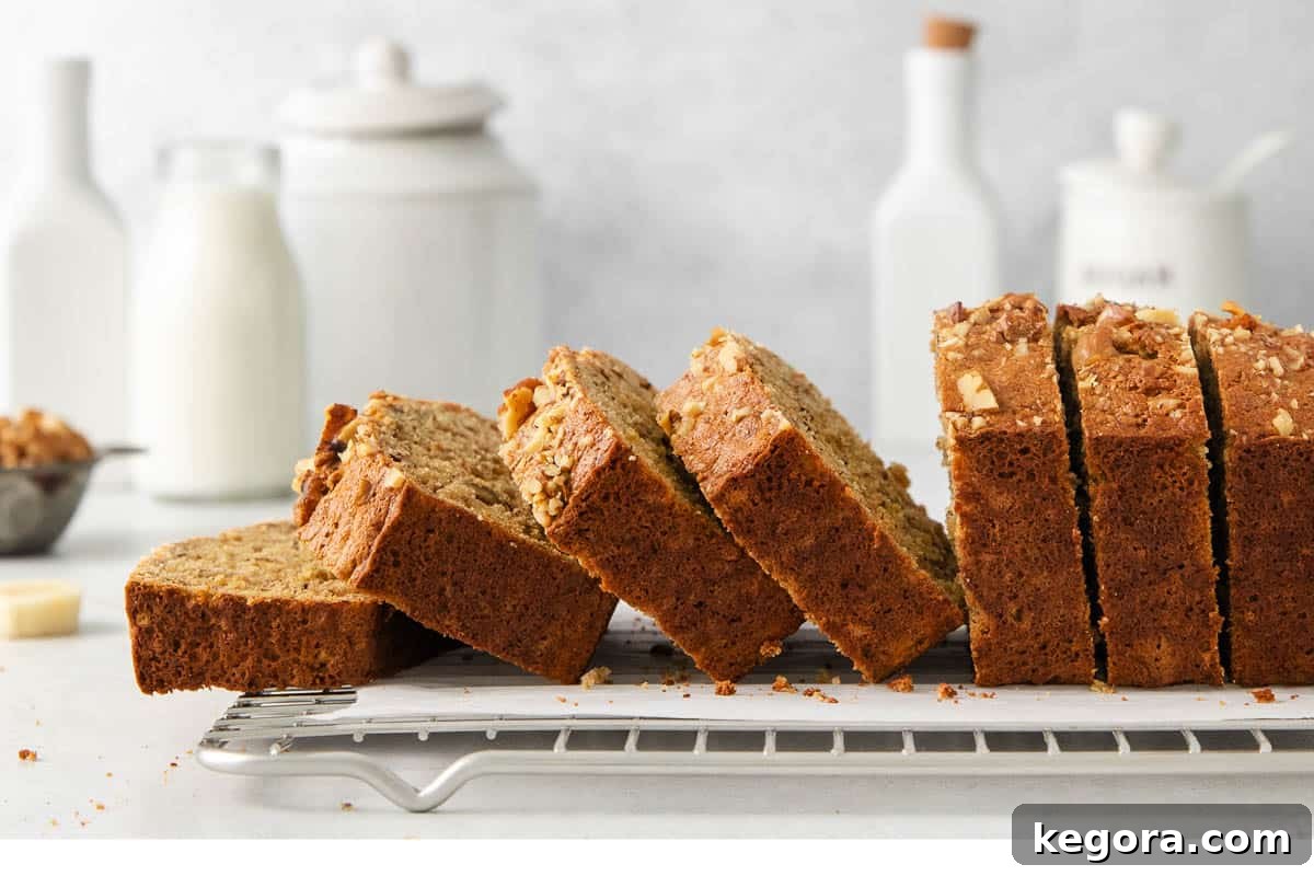 Wholesome Oat Banana Loaf 8 Several slices of oat flour banana bread displayed on a wire rack, showcasing its moist interior.
