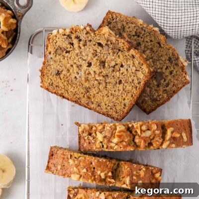 An overhead view of banana bread sliced on a wire rack