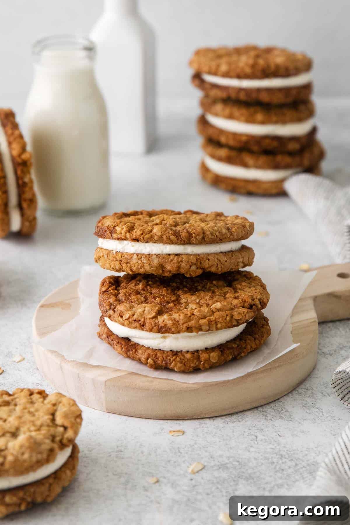 oatmeal cream pies on a platter, with milk and more cookies in the background