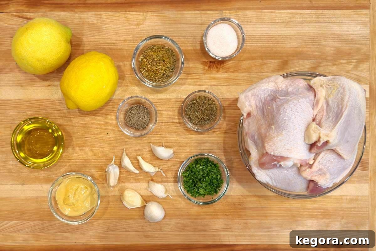 Zesty Greek Chicken Thighs 4 Various Greek Lemon Chicken Thighs ingredients laid out on a wooden cutting board, including lemons, garlic, herbs, and olive oil.