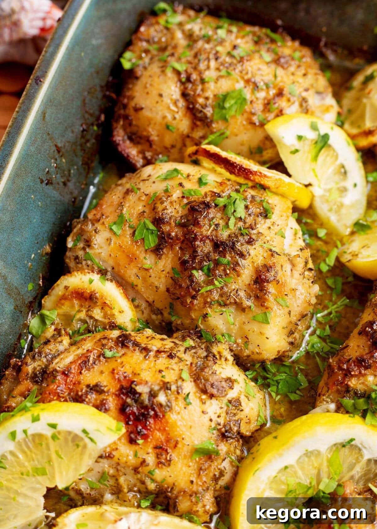Zesty Greek Chicken Thighs 8 A beautifully plated serving of Greek Lemon Chicken Thighs, garnished with fresh herbs and lemon wedges, ready to eat.