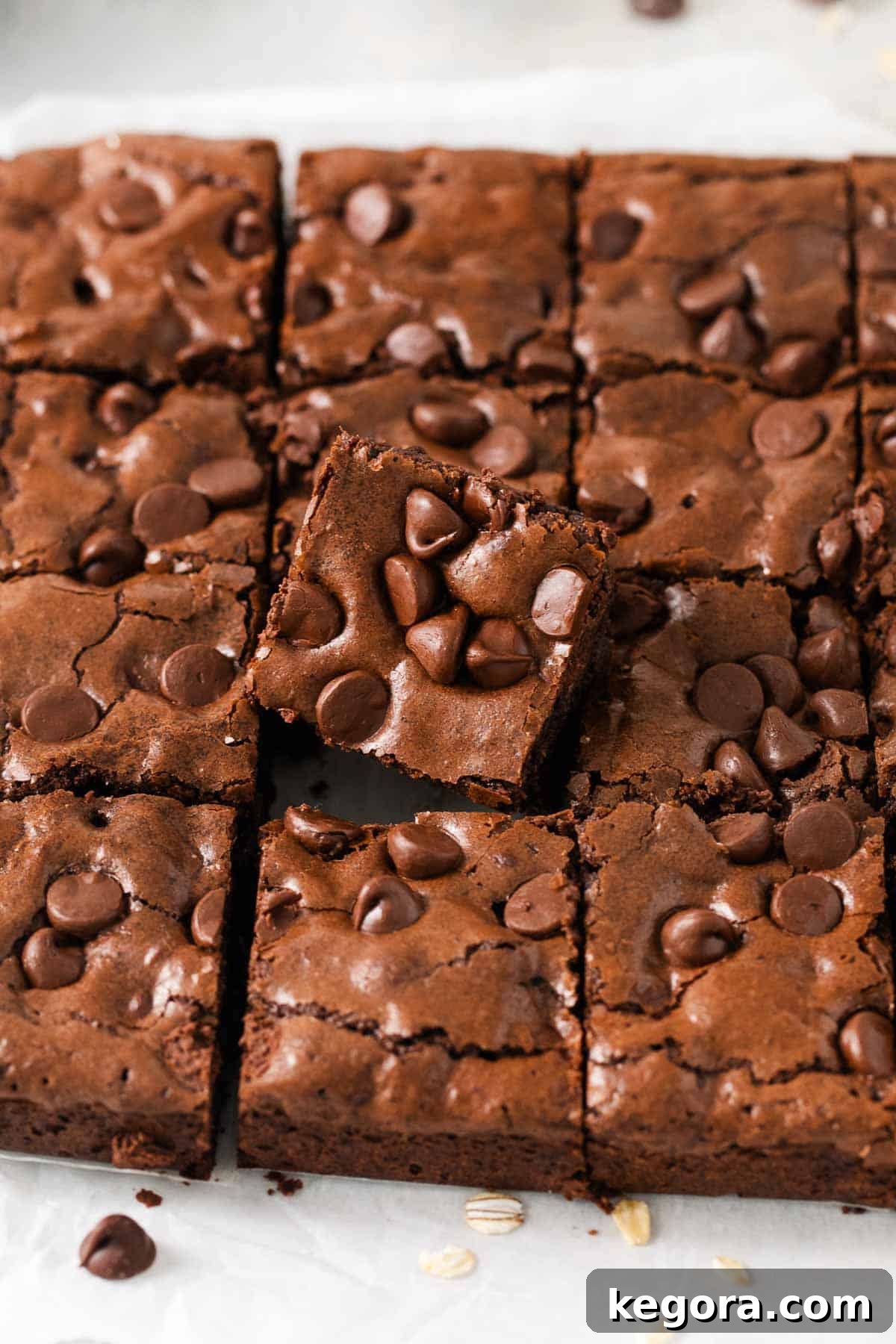 Oat flour brownies cut up in a baking dish, showcasing their rich, fudgy texture and shiny top