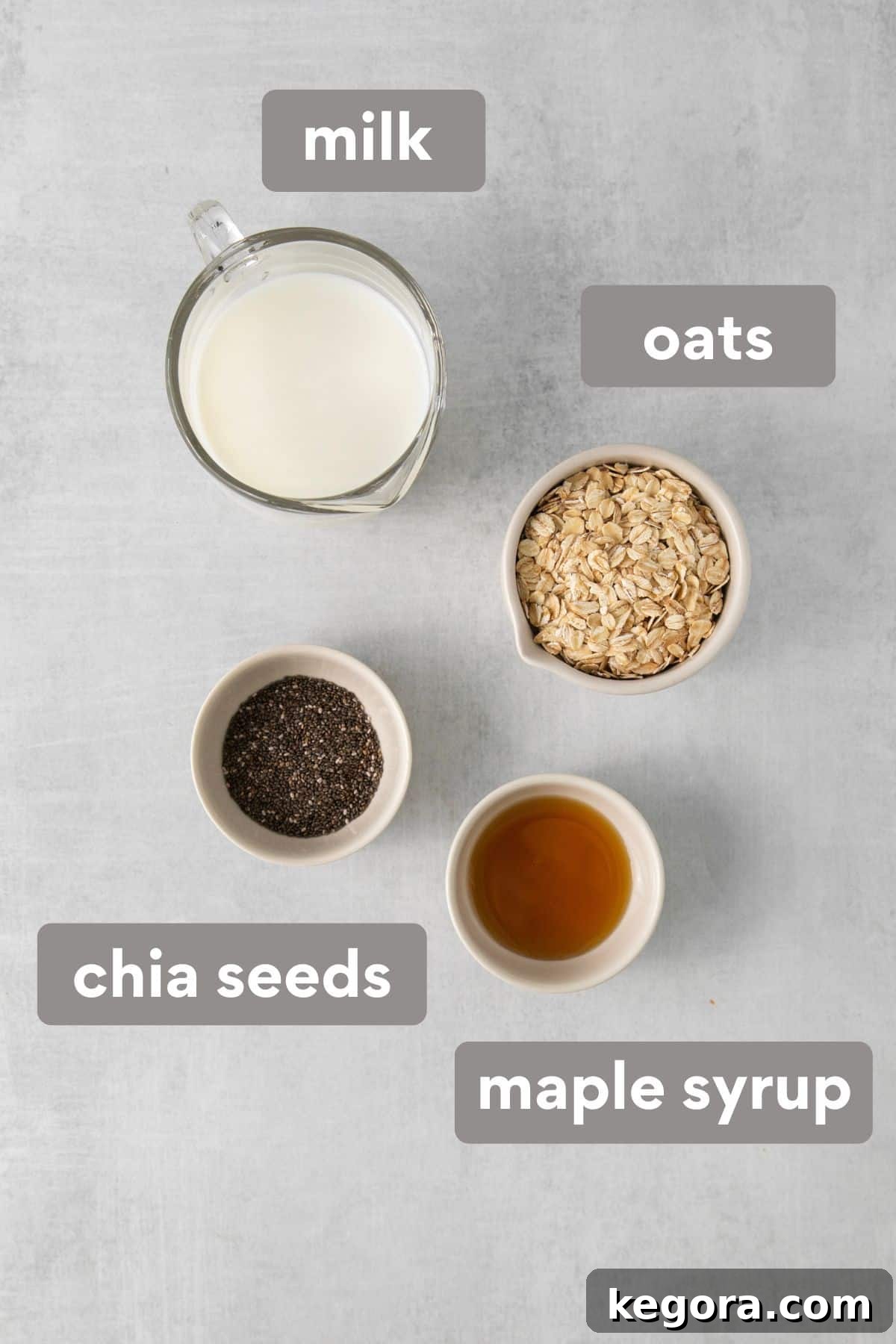 Overnight oats ingredients neatly laid out on a countertop, including oats, milk, honey, and chia seeds.