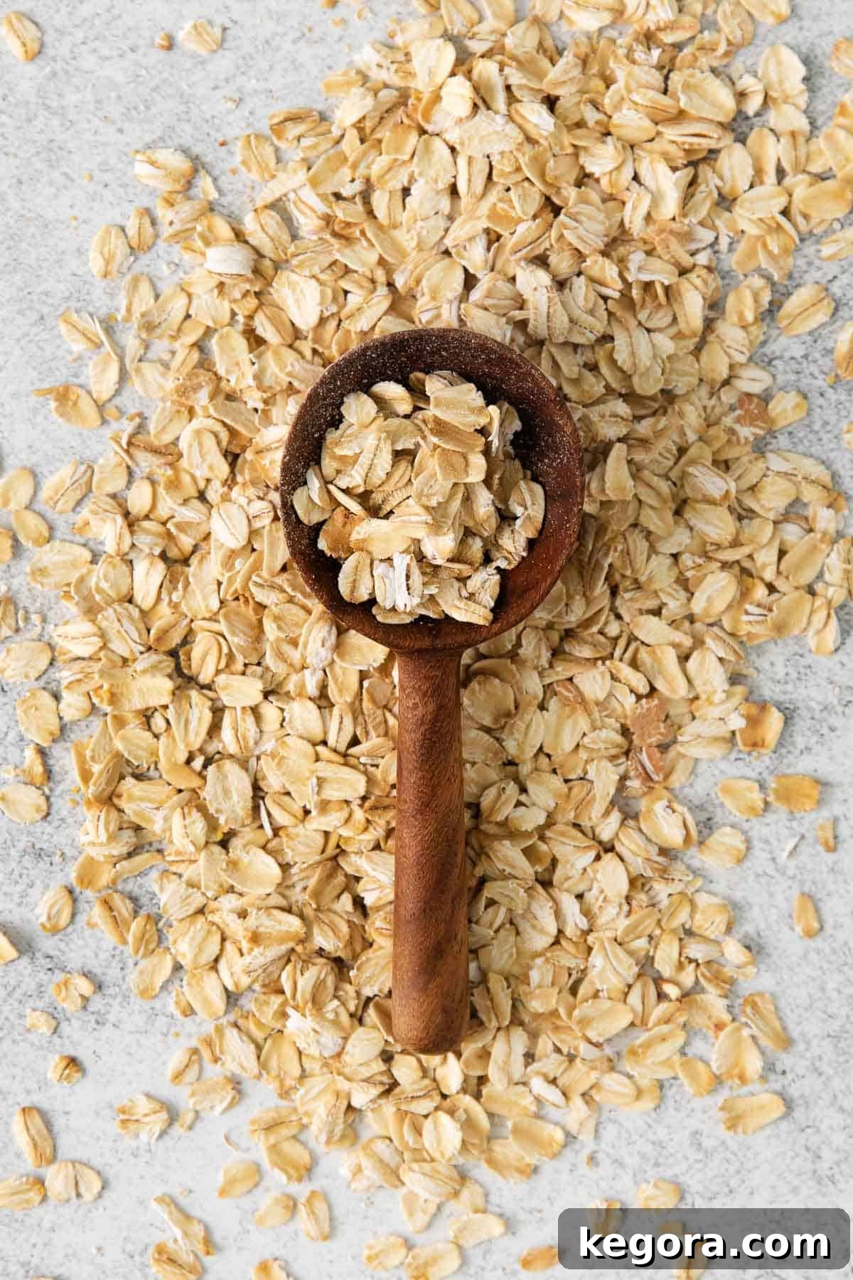 The Truth About Oatmeal and Gluten 3 Overhead shot of oats in a bowl with a wooden spoon, symbolizing natural and wholesome grains.