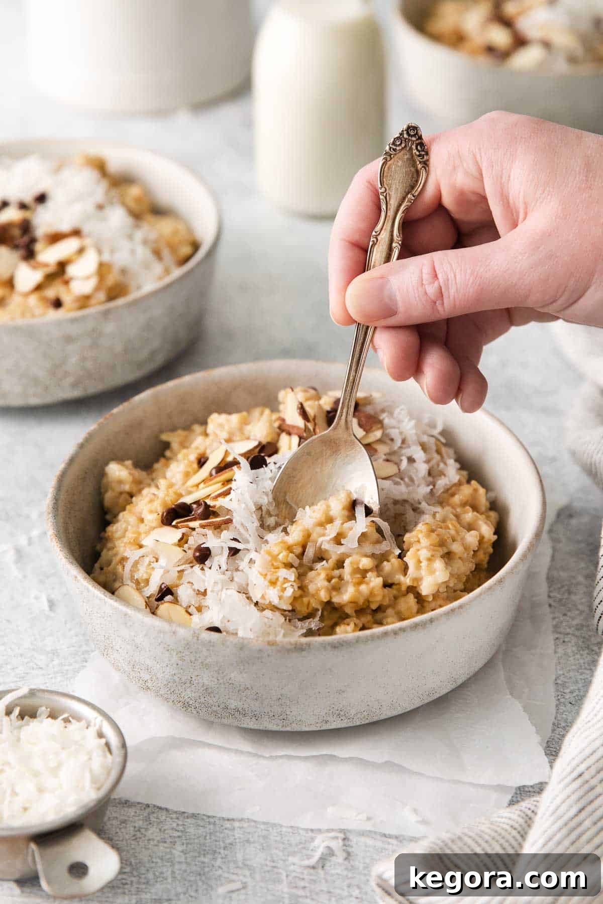 The Truth About Oatmeal and Gluten 5 A bowl of hearty steel-cut oats with a hand scooping a bite, emphasizing its wholesome nature.