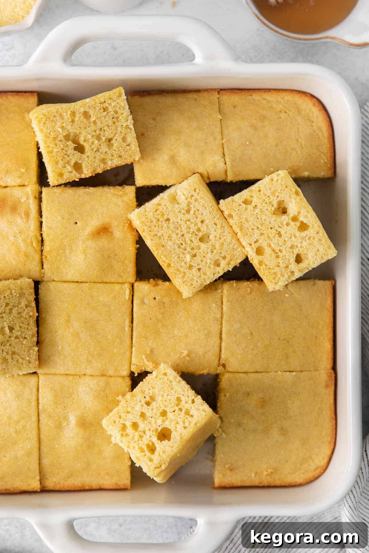 The Ultimate Gluten-Free Cornbread 3 golden brown gluten-free cornbread in a cast iron skillet, ready to be served.