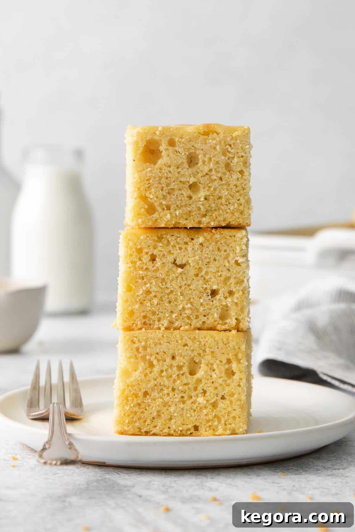 The Ultimate Gluten-Free Cornbread 9 Several golden slices of gluten-free cornbread stacked on a rustic plate, ready to be served.