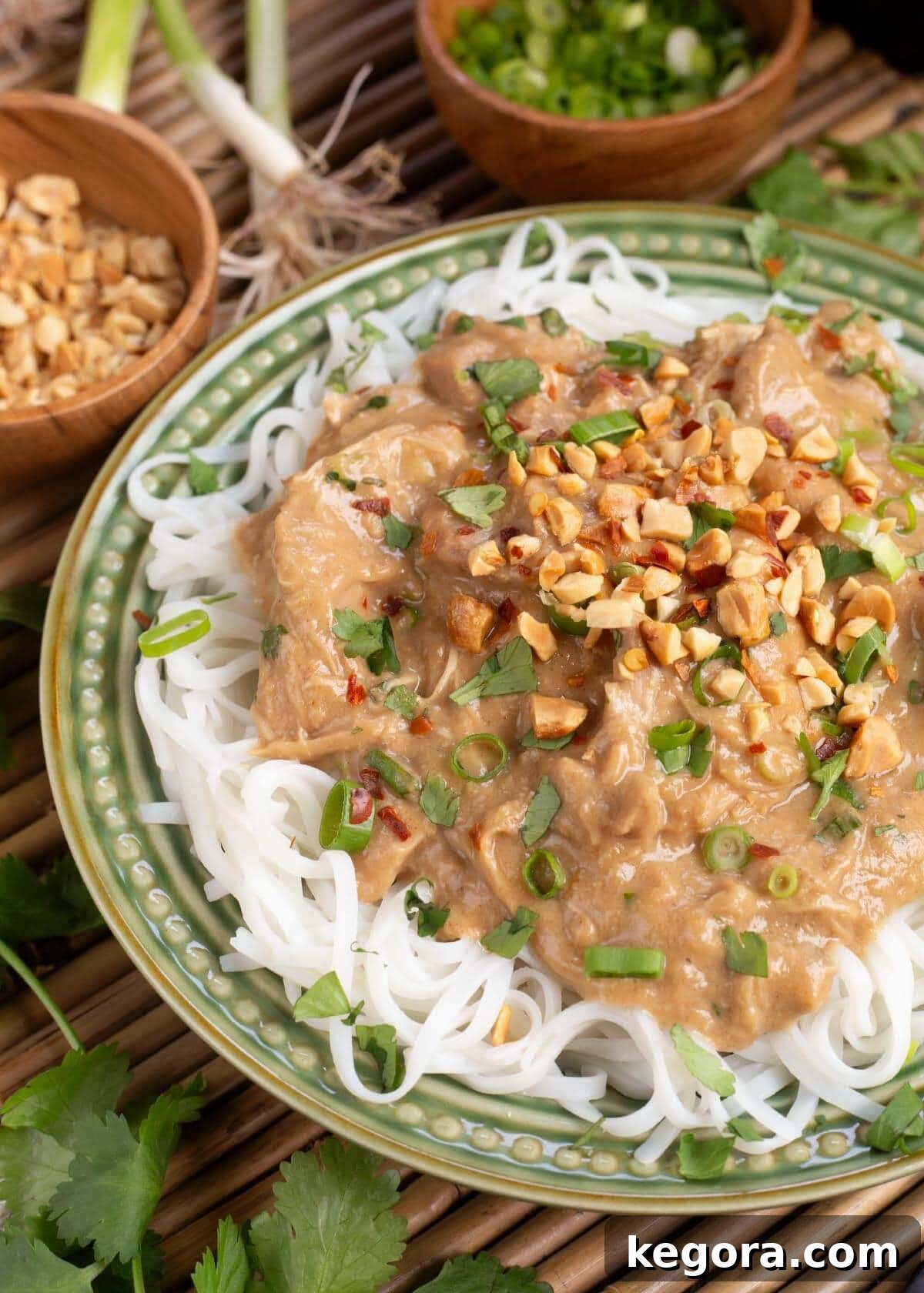 Crockpot Thai Peanut Chicken in a bowl with chopsticks