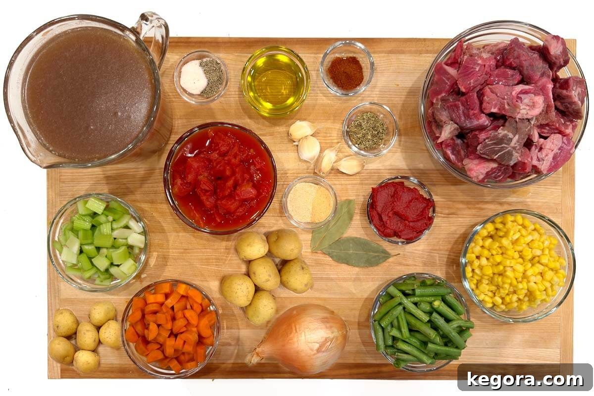 Wholesome Slow Cooker Beef and Garden Vegetable Soup 4 A selection of fresh ingredients for Crockpot Vegetable Beef Soup laid out on a wooden board
