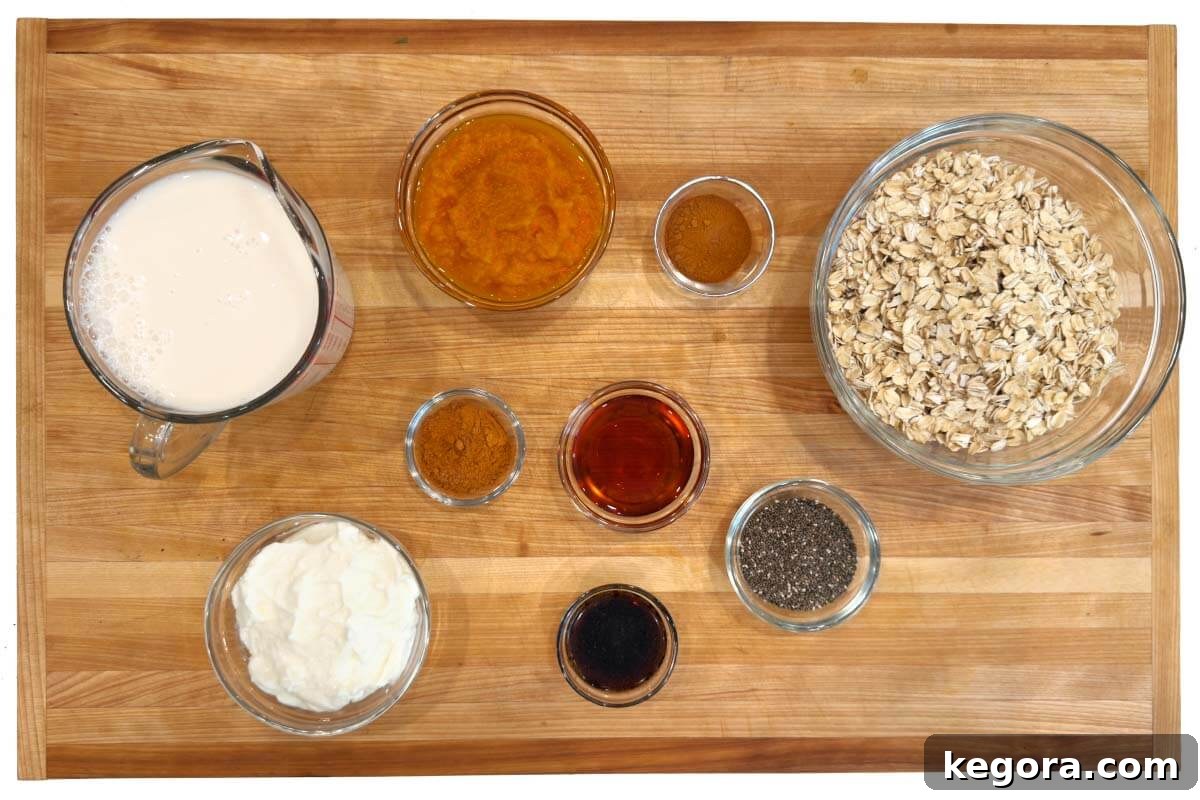 Pumpkin Spice Overnight Delight 4 Ingredients for Pumpkin Overnight Oats laid out on a wooden board
