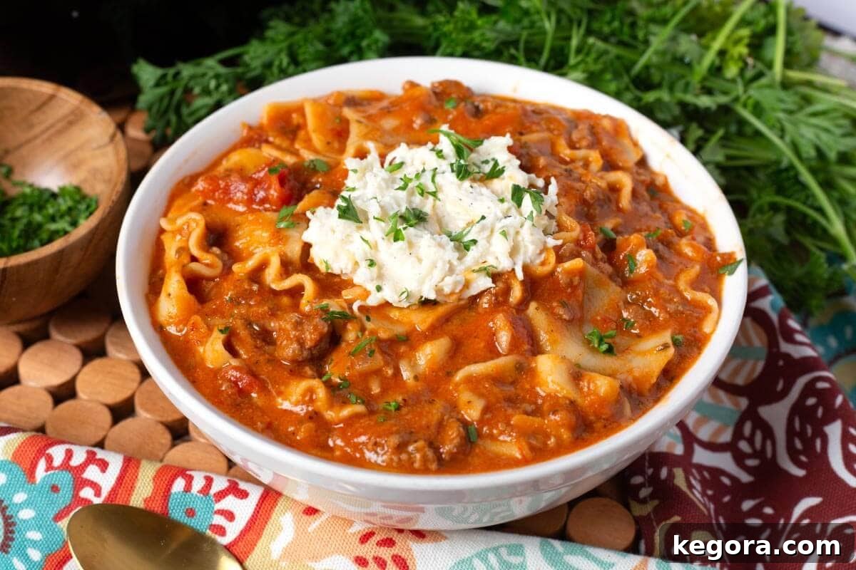 Effortless Slow Cooker Lasagna Soup 3 An overhead shot of Crockpot Lasagna Soup simmering in a slow cooker, showcasing the rich tomato broth and meat sauce.