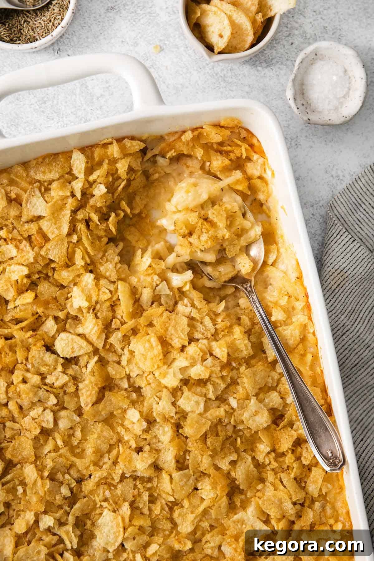 Ultimate Gluten-Free Cheesy Potato Bake 10 A close-up of gluten-free cheesy potatoes, showing the creamy texture and golden crust, with a serving spoon.