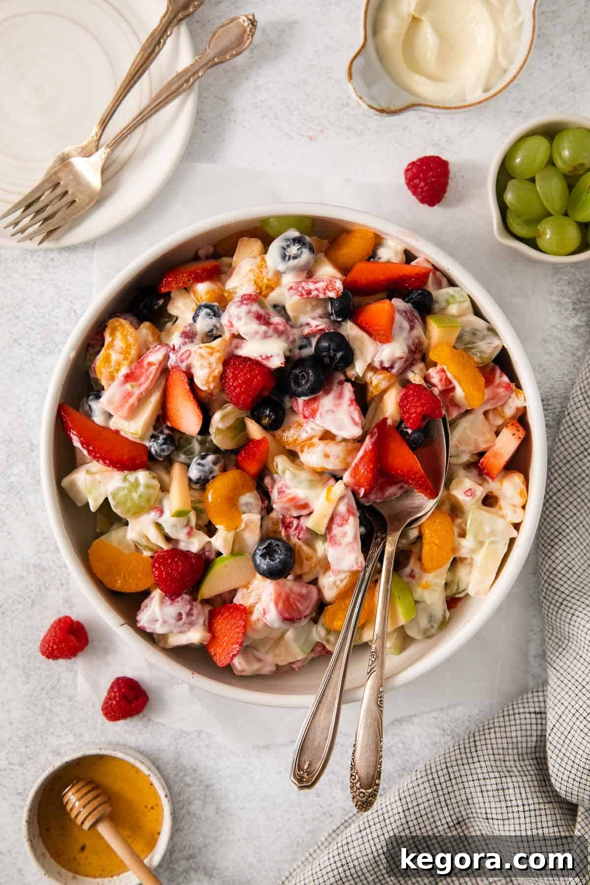 Festive Easter Fruit Delight 9 An overhead view of the colorful Easter fruit salad beautifully arranged in a large white bowl, garnished with fresh berries and a hint of green.