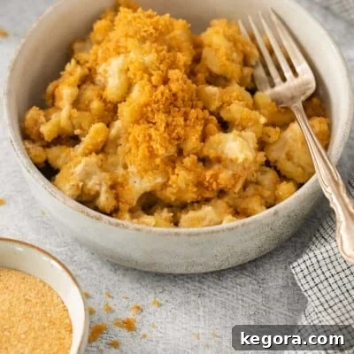 Dairy-free mac and cheese in a bowl with a fork, ready to be enjoyed.