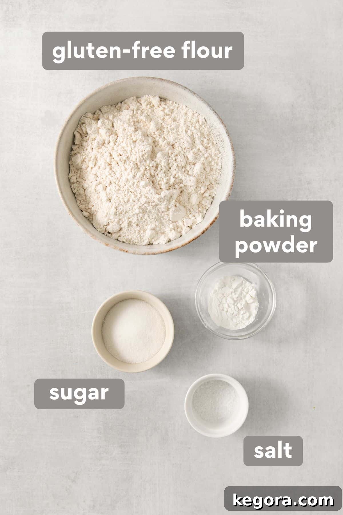 Naturally Sweet Gluten-Free Banana Hotcakes 3 Collection of dry ingredients for banana pancakes on a clean countertop, including flour, sugar, baking powder, and salt.