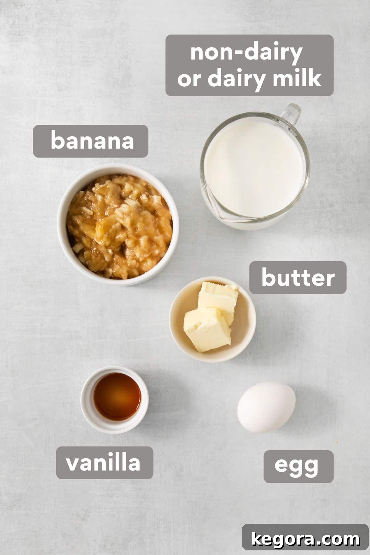 Naturally Sweet Gluten-Free Banana Hotcakes 4 Wet ingredients for banana pancakes on a countertop, including milk, egg, melted butter, vanilla extract, and mashed bananas.