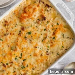 Layers of gluten-free scalloped potatoes in a rustic baking dish.