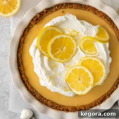 An overhead view of a vibrant gluten-free lemon cream pie, showcasing its smooth, creamy filling and delicate crust, ready to be sliced.
