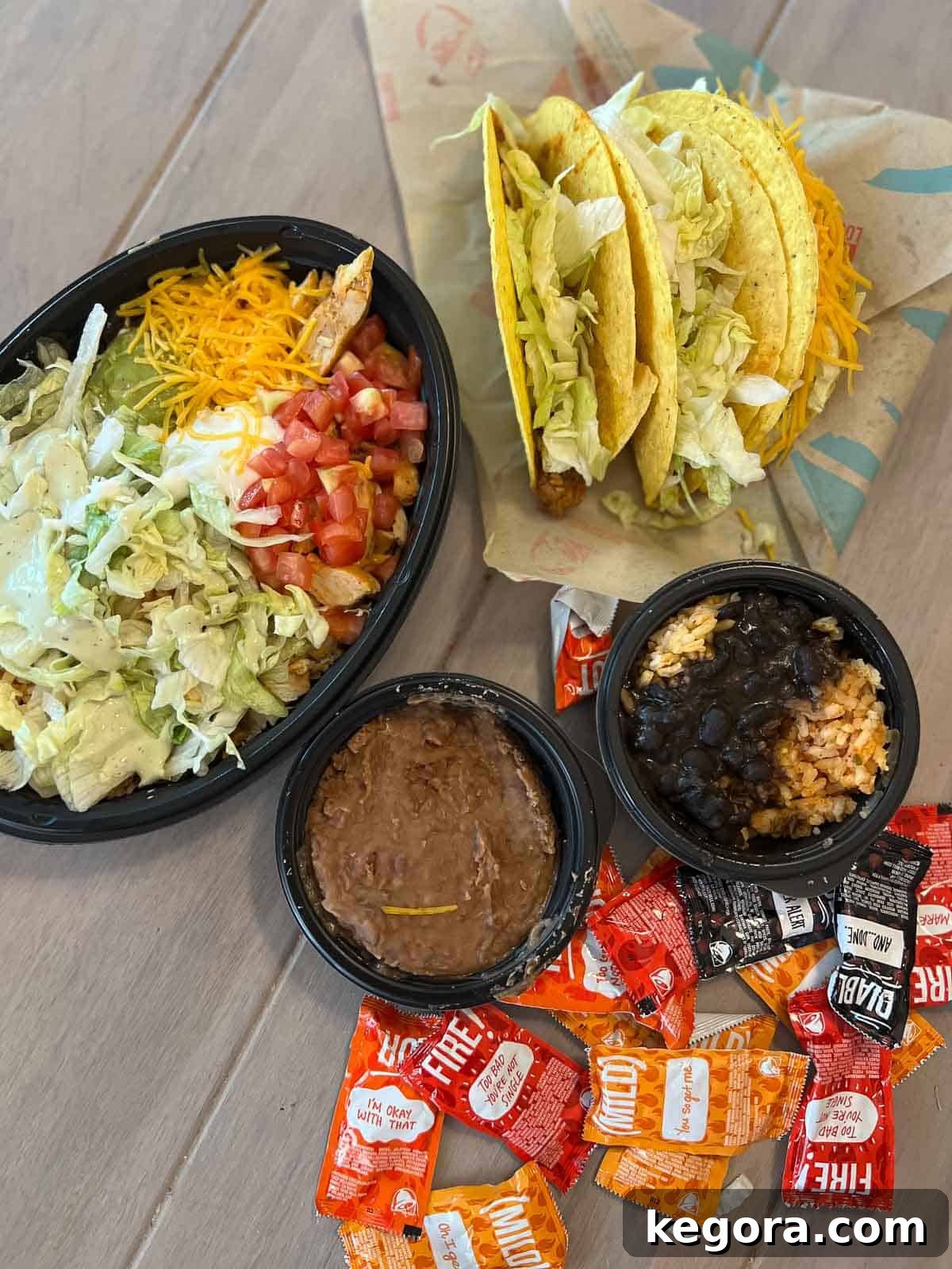Taco Bell Gluten-Free Menu 2025 3 overhead shot of tacos, beans and taco bowl with hot sauce from taco bell